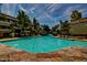 Refreshing community pool with stone deck and surrounding buildings at 1331 W Baseline Rd # 251, Mesa, AZ 85202