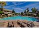 Expansive community pool with stone deck and multiple lounge chairs at 1331 W Baseline Rd # 251, Mesa, AZ 85202
