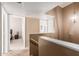 Upstairs hallway with light fixture and access to bedrooms at 1331 W Baseline Rd # 251, Mesa, AZ 85202