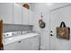 Laundry room with side-by-side washer and dryer, cabinets, and hooks at 14231 N Desert Flower Dr, Fountain Hills, AZ 85268