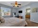 Main bedroom with king bed, ceiling fan, and access to bathroom at 1458 S Kadota Dr, Gilbert, AZ 85296