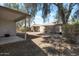 The backyard features low-maintenance landscaping, a covered patio, and a privacy wall for relaxation at 15144 W Washington St, Goodyear, AZ 85338