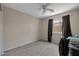 Cozy bedroom with a ceiling fan, carpet flooring, natural light, and ample closet space at 15144 W Washington St, Goodyear, AZ 85338