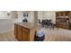 Open concept kitchen with a center island flowing into the dining area with ample seating at 15144 W Washington St, Goodyear, AZ 85338