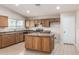 Kitchen with island, wood cabinets and stainless steel appliances at 15144 W Washington St, Goodyear, AZ 85338