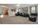 Open living room features three leather seats, large picture, and kitchen access at 15144 W Washington St, Goodyear, AZ 85338