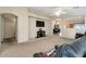Spacious living room with neutral carpet, a ceiling fan, and an open floor plan at 15144 W Washington St, Goodyear, AZ 85338