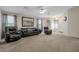 Large open living room features three leather seats and lots of natural light at 15144 W Washington St, Goodyear, AZ 85338