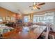 Large dining area with hardwood floors and a wooden table, adjacent to living room at 16364 W Roosevelt St, Goodyear, AZ 85338