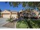 House exterior with a three-car garage and landscaping at 16364 W Roosevelt St, Goodyear, AZ 85338