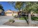 Three-car garage and lovely landscaping in front of the house at 16364 W Roosevelt St, Goodyear, AZ 85338