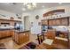 Spacious kitchen with island, wooden cabinets and a large window at 16364 W Roosevelt St, Goodyear, AZ 85338