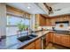 Kitchen features a large island and double sink with granite countertops at 16364 W Roosevelt St, Goodyear, AZ 85338