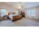 Bright main bedroom with ceiling fan and large windows at 16364 W Roosevelt St, Goodyear, AZ 85338