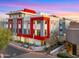 Modern three-story building with red and gray accents at sunset at 16510 N 92Nd St # 1006, Scottsdale, AZ 85260