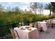 Charming outdoor dining area with views of lush greenery, featuring an intimate table setting at 16510 N 92Nd St # 1006, Scottsdale, AZ 85260