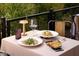 Elegant outdoor table setting with gourmet dishes, a glass of wine, and stylish accessories at 16510 N 92Nd St # 1006, Scottsdale, AZ 85260