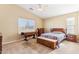 Cozy bedroom with wood furniture and carpeted floors at 19339 N Madison Rd, Maricopa, AZ 85139