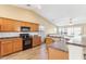 Kitchen with wood cabinets, granite counters, and island at 19339 N Madison Rd, Maricopa, AZ 85139