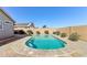 Relaxing kidney-shaped pool surrounded by a stone patio and landscaping at 19339 N Madison Rd, Maricopa, AZ 85139