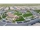 Community clubhouse and recreational facilities, including green spaces, pool, and parking, nestled within a residential area at 210 E Bergamot Ln, Queen Creek, AZ 85140