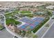 An aerial view showcases the community pickleball courts, landscaping, and nearby clubhouse for residents' enjoyment at 210 E Bergamot Ln, Queen Creek, AZ 85140