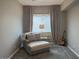 Cozy bedroom featuring a chaise lounge, neutral tones, and serene natural light at 210 E Bergamot Ln, Queen Creek, AZ 85140