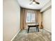 Cozy bedroom with neutral walls, carpet, and a desk by the window at 210 E Bergamot Ln, Queen Creek, AZ 85140