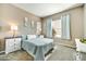 Comfortable bedroom featuring a queen-size bed, carpet flooring, and bright windows with natural light at 210 E Bergamot Ln, Queen Creek, AZ 85140