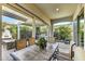 Inviting covered patio features dining area, outdoor kitchen, and lush landscaping for relaxing outdoor living at 210 E Bergamot Ln, Queen Creek, AZ 85140