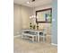 Bright dining area features neutral tones, a rectangular mirror, and a wooden table with bench at 210 E Bergamot Ln, Queen Creek, AZ 85140