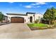 Charming single-Gathering home featuring a two-car garage, manicured lawn, and inviting curb appeal at 210 E Bergamot Ln, Queen Creek, AZ 85140