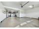 Spacious garage with epoxy floors, ample storage, and a wall-mounted television at 210 E Bergamot Ln, Queen Creek, AZ 85140