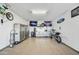 Well-organized garage with epoxy floors, storage cabinets, and motorcycle at 210 E Bergamot Ln, Queen Creek, AZ 85140