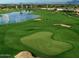 Expansive golf course view featuring a serene lake and immaculately manicured green at 210 E Bergamot Ln, Queen Creek, AZ 85140