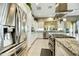 Updated kitchen with stainless steel refrigerator and appliances, granite countertops, and eat in island at 210 E Bergamot Ln, Queen Creek, AZ 85140