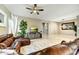 Comfortable living room with plush leather seating, ceiling fan, and neutral colors at 210 E Bergamot Ln, Queen Creek, AZ 85140