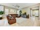 Comfortable living room with plush leather seating, ceiling fan, and natural light at 210 E Bergamot Ln, Queen Creek, AZ 85140