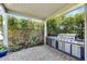 Outdoor kitchen boasts stainless steel grill and ample counter space, set in a private, landscaped backyard at 210 E Bergamot Ln, Queen Creek, AZ 85140