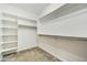 Walk-in closet with carpet flooring and custom shelving to maximize space and organization at 210 E Bergamot Ln, Queen Creek, AZ 85140