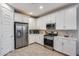 Modern kitchen featuring stainless steel appliances and white cabinetry at 2156 W Sierra Sunset Trl, Phoenix, AZ 85085