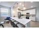 Modern kitchen with white cabinets, island, and breakfast bar at 2156 W Sierra Sunset Trl, Phoenix, AZ 85085