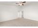 Spacious bedroom with carpeted floors and ceiling fan at 22270 W Desert Bloom St, Buckeye, AZ 85326