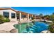 Refreshing pool with large rocks and a covered patio at 24623 S Lakeway Se Cir, Sun Lakes, AZ 85248