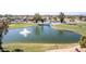 Community pond with water fountain feature at 25244 S Saddletree Dr, Sun Lakes, AZ 85248