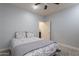Bedroom with floral bedding, ceiling fan, and door to bathroom at 2734 E Birchwood Pl, Chandler, AZ 85249