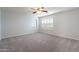 Bright bedroom with ceiling fan and window shutters at 2734 E Birchwood Pl, Chandler, AZ 85249