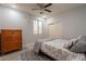 Bedroom with wood dresser, ceiling fan, and double doors at 2734 E Birchwood Pl, Chandler, AZ 85249