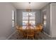 Bright dining room with wood table and chairs, and view to living room at 2734 E Birchwood Pl, Chandler, AZ 85249