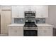 Modern kitchen with white cabinets, stainless steel range and microwave at 2734 E Birchwood Pl, Chandler, AZ 85249
